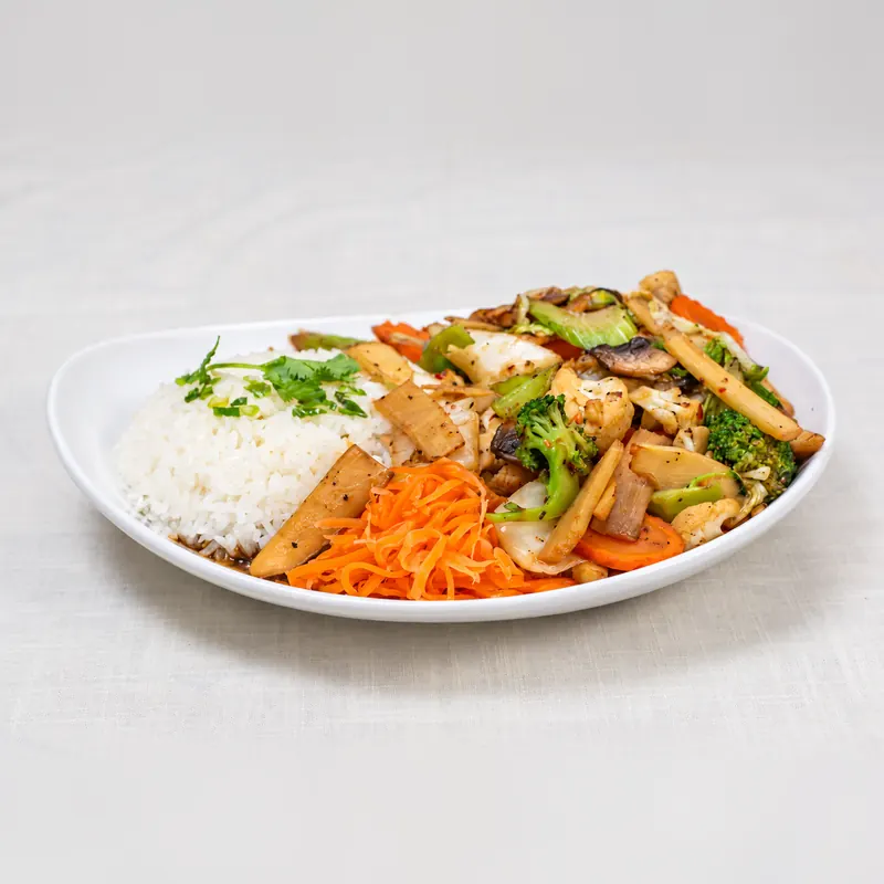 Stir-fried vegetables with steamed rice and pickled carrot